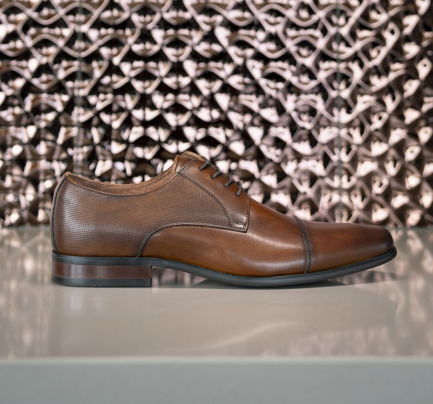 Click to shop Florsheim best sellers. Image features the Postino cap toe in cognac.