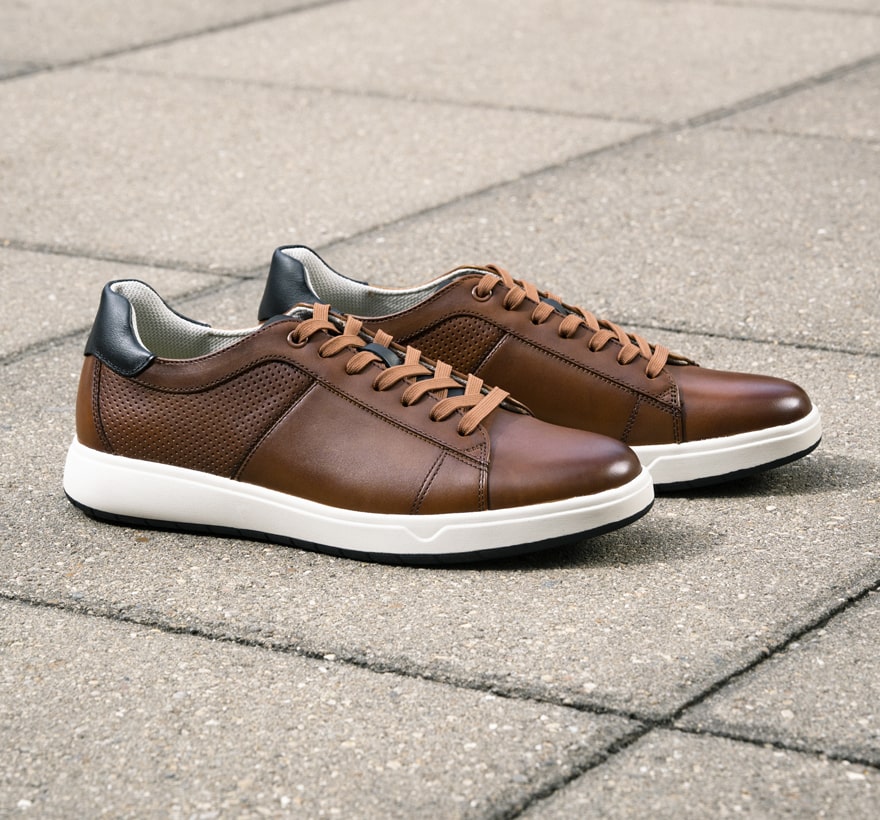 Click to shop Florsheim sneakers. Image features the Heist in cognac.