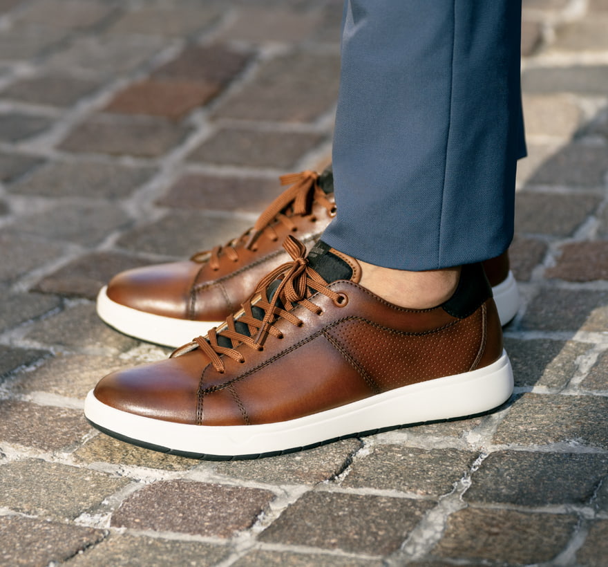 Click to shop Florsheim sneakers. Image features the Heist in cognac.