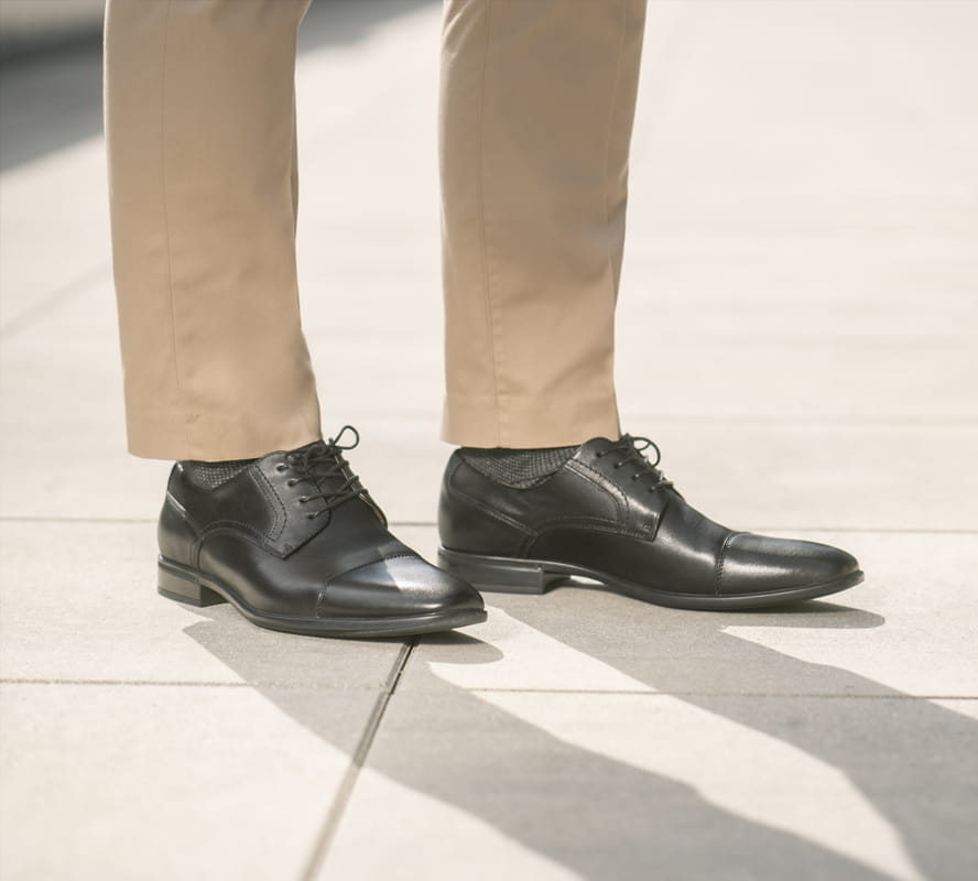 Shop Florsheim Top Sellers featuring the Zaffiro Cap Toe Oxford in Black on concrete tiles.