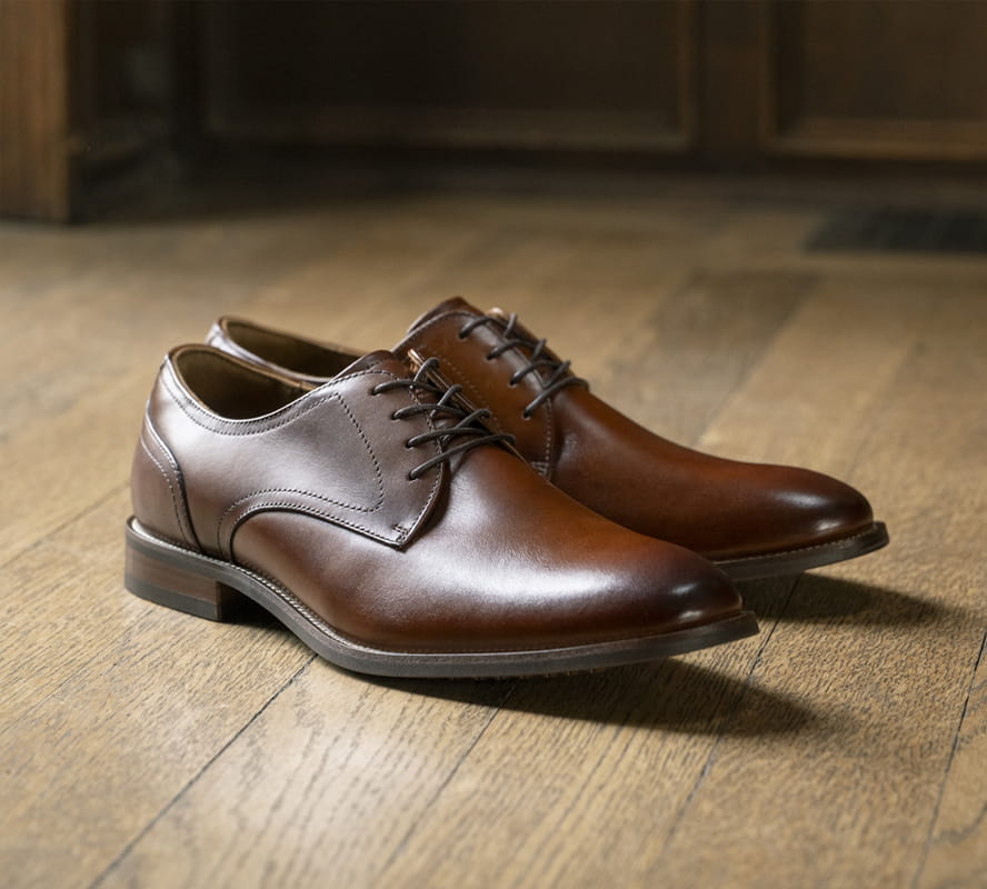 Shop Florsheim top sellers featuring the Rucci Plain Toe Oxford on a wood floor. 
