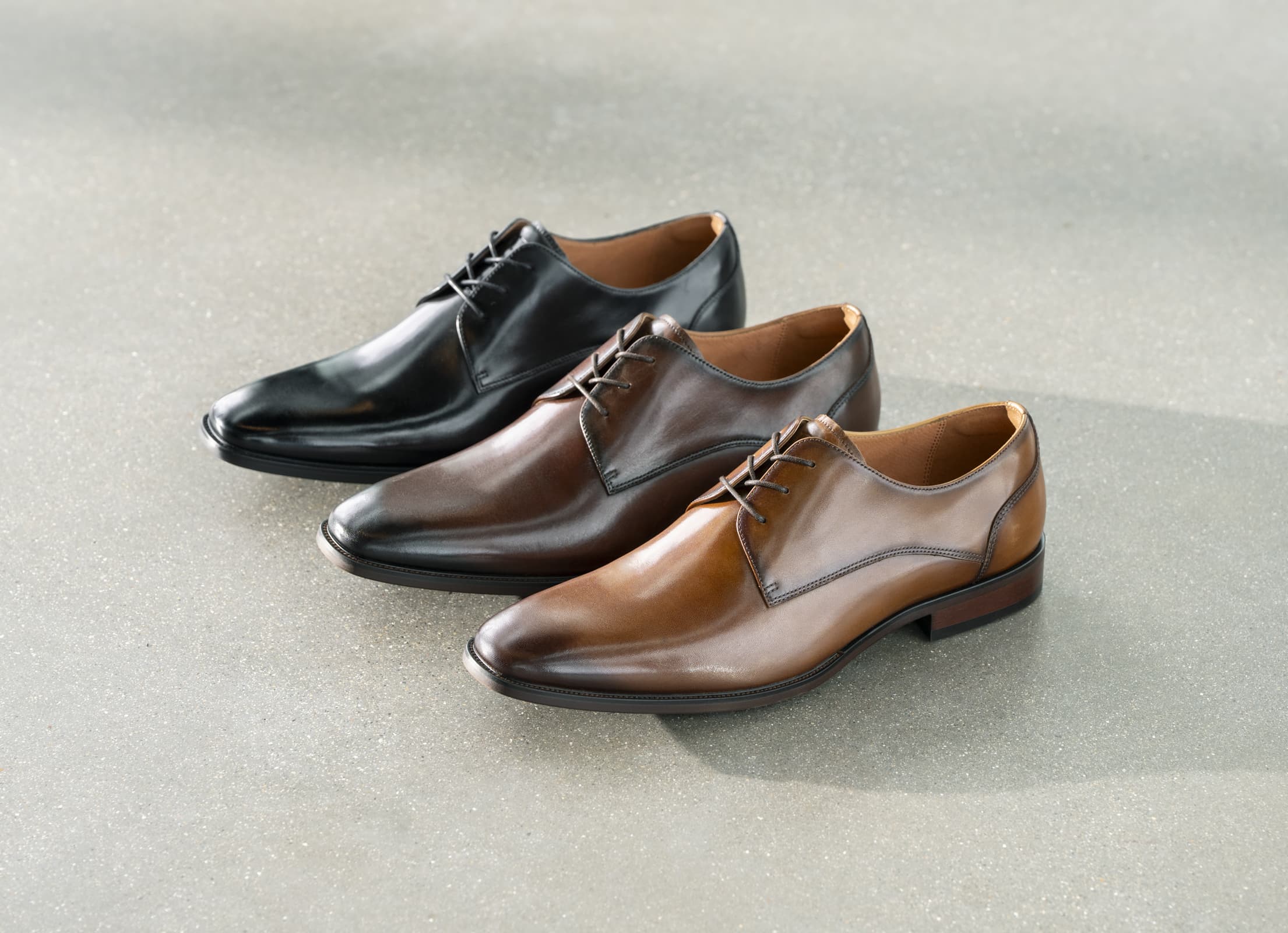 Shop the Florsheim Sorrento Lux featuring the Sorrento Lux in black, brown and cognac on a concrete background.