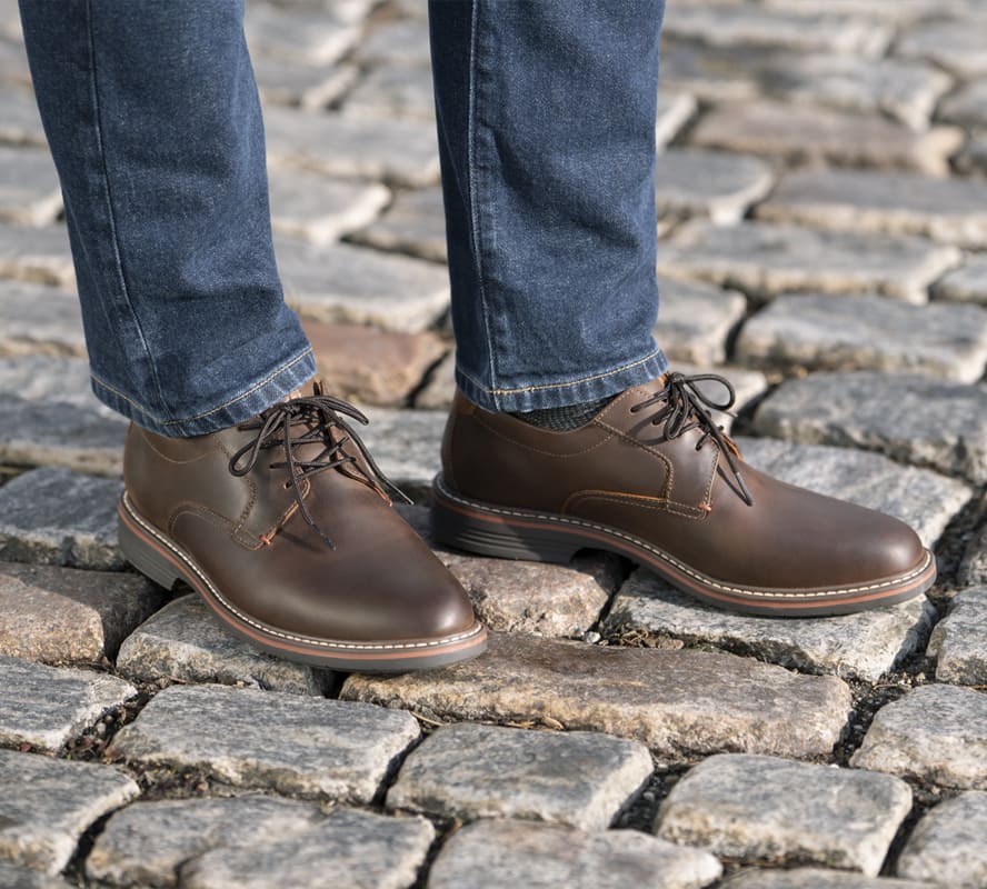 Shop the Florsheim Hybrid category featuring the Norwalk Plain Toe Oxford in Brown CH on a stone background.
