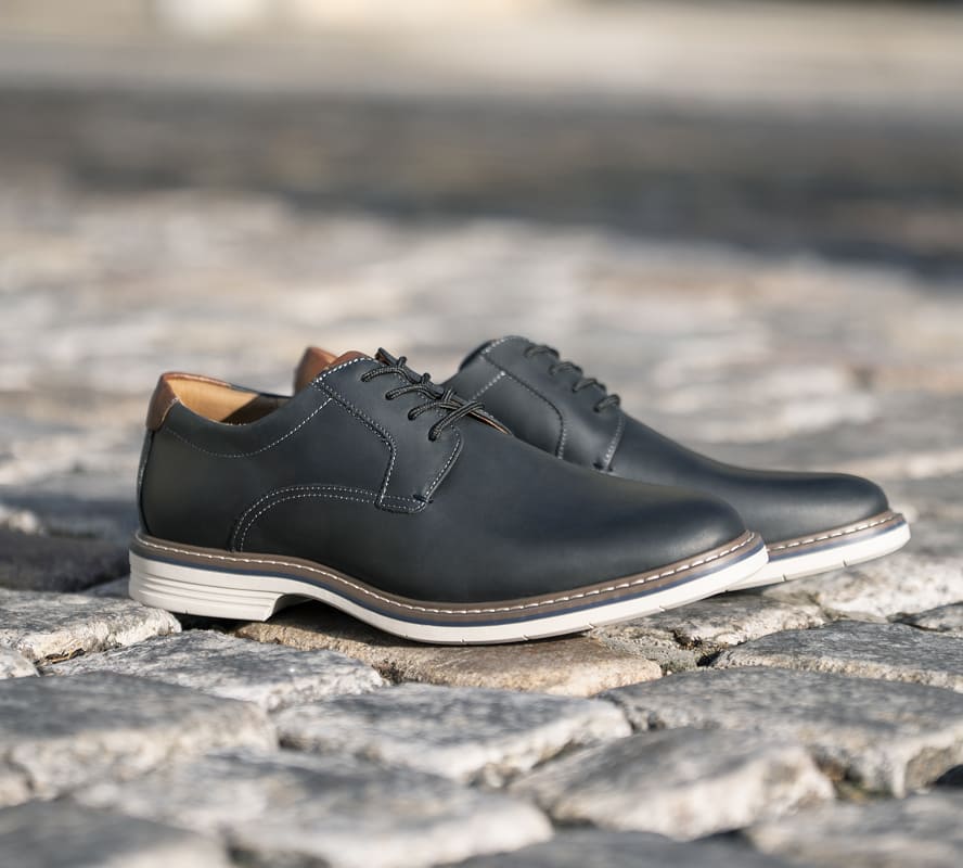Shop Florsheim hybrids featuring the Norwalk plain toe oxford in black on a brick street.