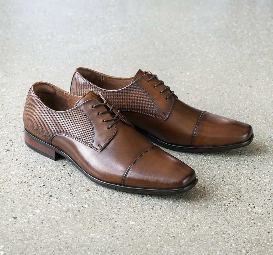 Click to shop Florsheim best sellers. Image features the Postino cap toe in cognac.