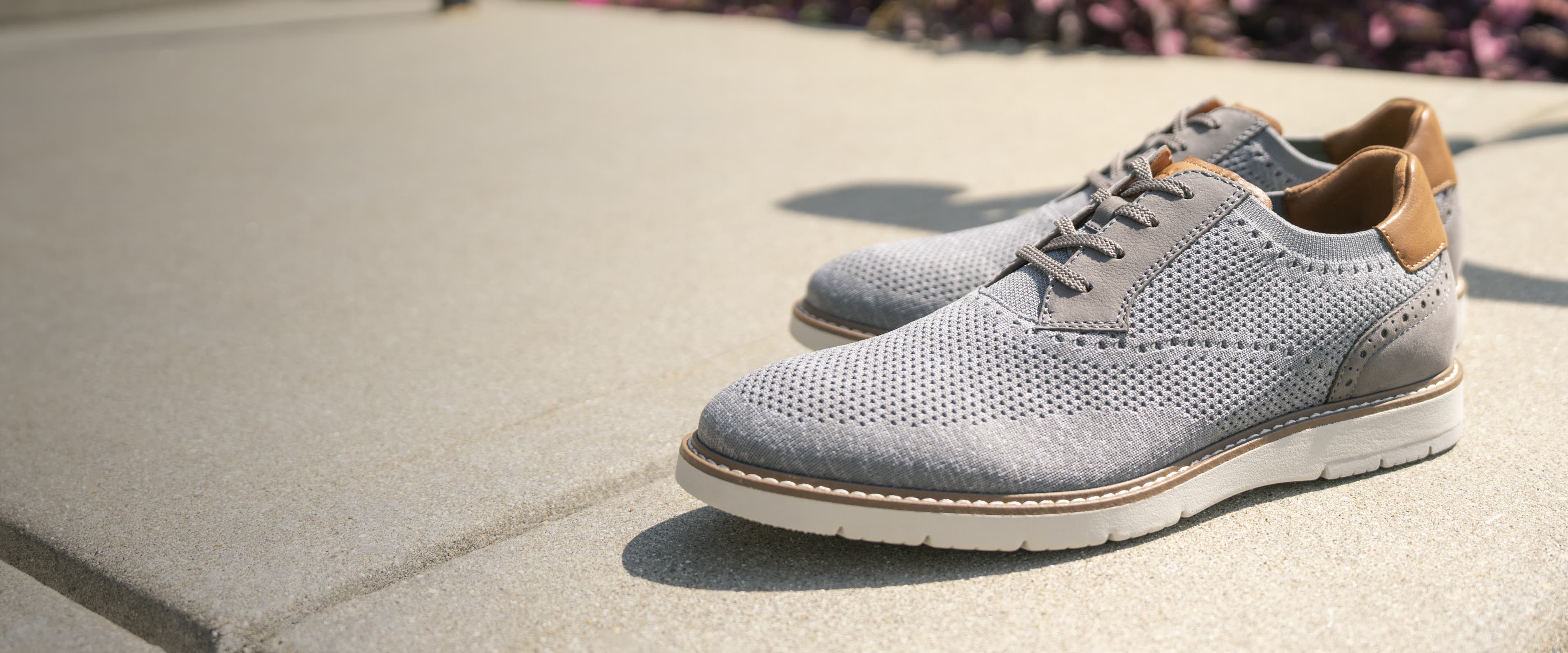 Florsheim new arrivals featuring the Vibe Knit in grey on a sidewalk.