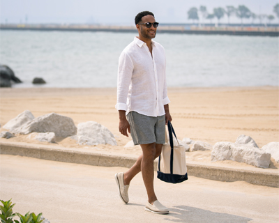 Image features a man walking on a beachfront wearing Florsheim loafers.