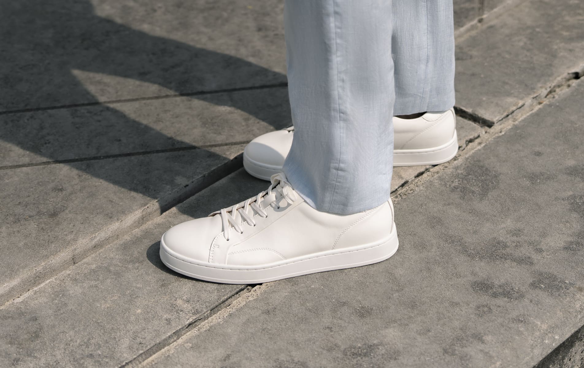 Shop Florsheim casuals featuring the Monopoli lace up sneaker in white on a concrete surface.