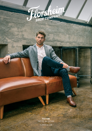Image of a model sitting on a couch wearing the Postino Cap Toe Balmoral Oxford in Cognac that was featured in Sports Illustrated magazine.