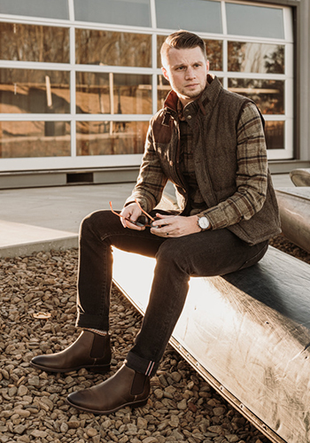 Image of social media influencer Matt Hartman sitting outside in the Uptown Plain Toe Gore Boot in Brown Crazy Horse.