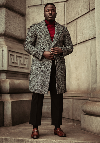 Image of social media influencer Owen Cain standing outside a brick building in the Postino Moc Toe Bit Slip On in Cognac.