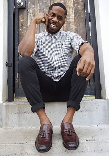 Image of social media influencer Chidi Ezemma wearing the Amelio Moc Toe Tassel Slip On in Burgundy while sitting on steps outside.