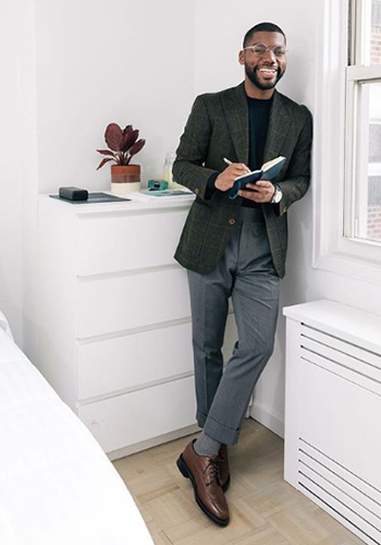 Image of social media influencer Brandon Bryant wearing the Kenmoor Wingtip Oxford in Cognac in his apartment.