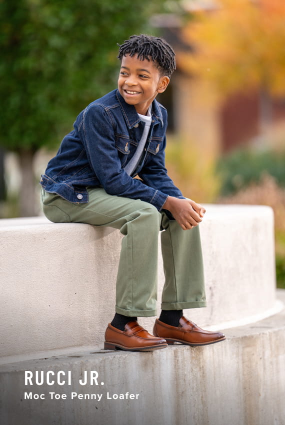 Kids Shoes view all category Image features the Rucci Jr. penny loafer in cognac.