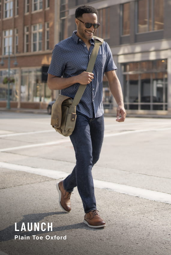 Men's Newest Shoes category. Image features the Launch plain toe oxford in cognac.
